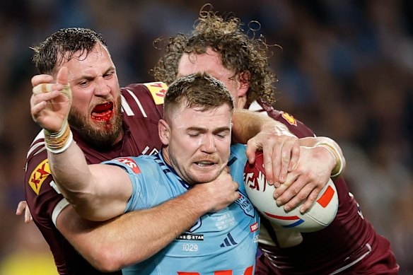 Hudson Young of the Blues is tackled by Kurt Capewell of the Maroons during game three of the Men’s State Of Origin series between New South Wales Blues and Queensland Maroons.