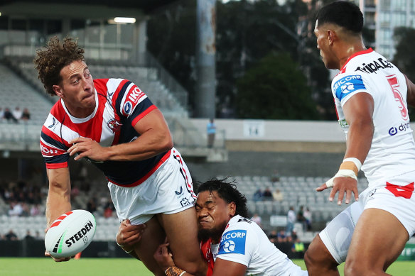 Mark Nawaqanitawase slips an offload against the Dragons on Sunday.