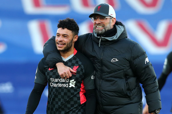 Alex Oxlade-Chamberlain and Jurgen Klopp, manager of Liverpool, celebrate following their team's victory.