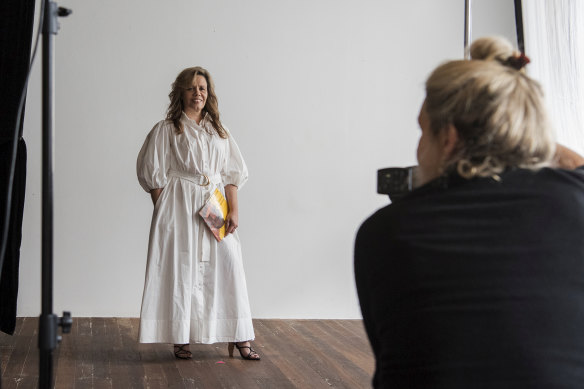 Behind the scenes of Aje's 2020 spring campaign featuring Yvonne Weldon holding 'Windradyne - A Wiradjuri Koorie' by Mary Coe & illustrated by Isabell Coe.