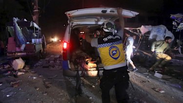 A White Helmet worker loads an injured man into an ambulance after Syrian government airstrikes hit the town of Maaret al-Numan, Idlib province.