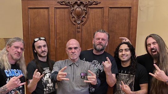 Kotara High School Principal Mark Snedded (third from right) with thrash metal band Vio-lence