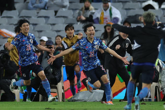 Kaoru Mitoma celebrates one of his two goals for Japan tonight.