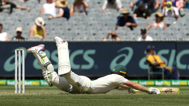 Tim Paine dives to make his ground after taking a quick single.