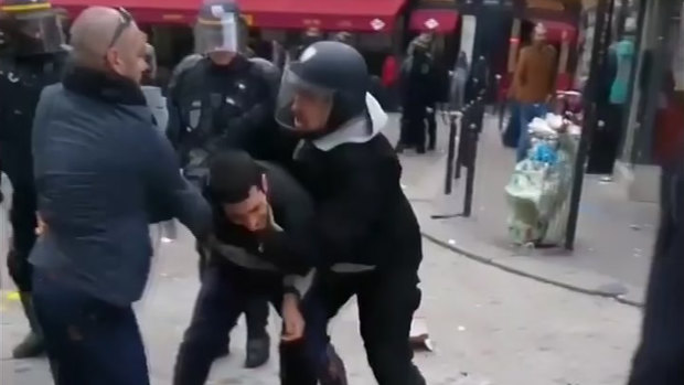 A man identified as Alexandre Benalla confronts a student during a May Day demonstration in Paris.