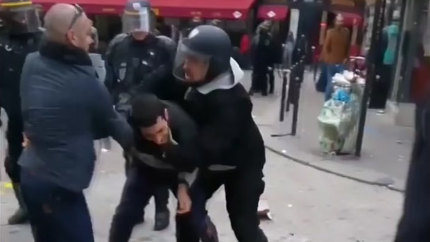 A man identified as Alexandre Benalla, right, a security chief to French President Emmanuel Macron, confronting a student during a May Day demonstration in Paris.