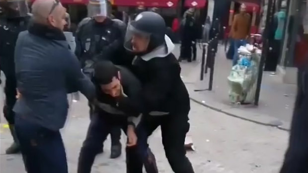 A man identified as Alexandre Benalla, right, a security chief to French President Emmanuel Macron, confronting a student during a May Day demonstration in Paris.