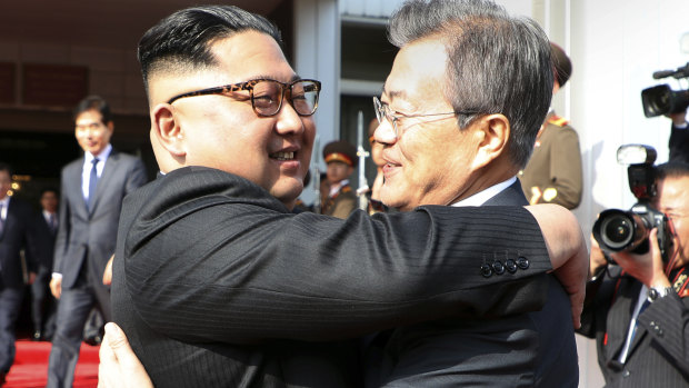 Kim Jong Un, left, and Moon Jae-in embrace each other after their meeting on May 26.
