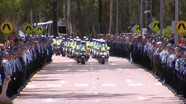 Police form a guard of honour after the memorial for Rachel McCrow and Matthew Arnold.