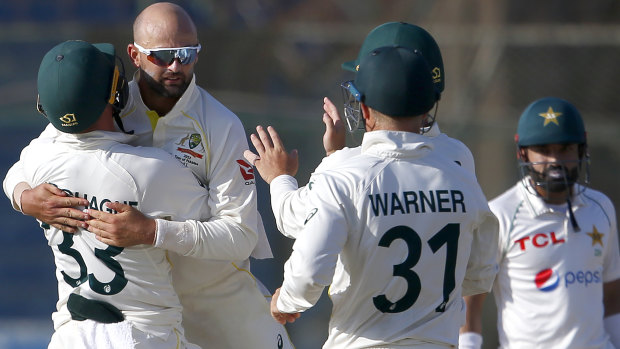 Nathan Lyon hugs Marnus Labuschagne after dismissing Faheem Ashraf on the final day.