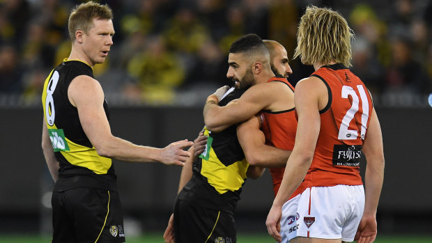 Jack Riewoldt and Dyson Heppell are joined at the coin toss by Bachar Houli and Adam Saad in a show of unity.