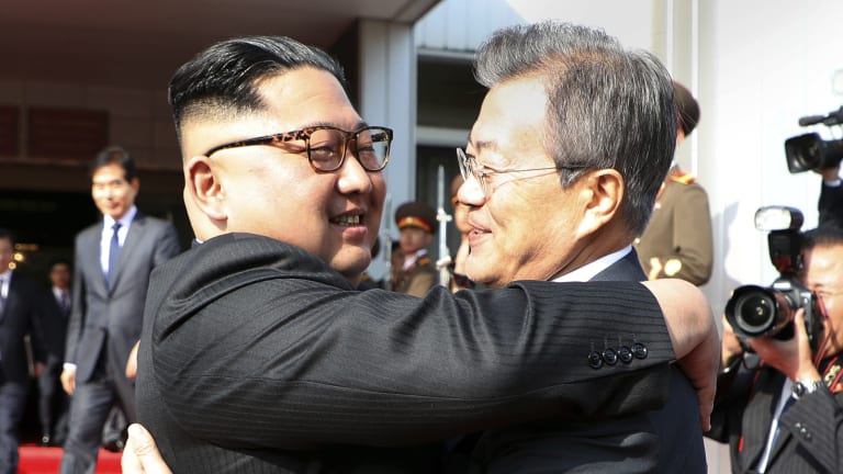 Kim Jong-un, left, and Moon Jae-in embrace after their meeting on May 26.