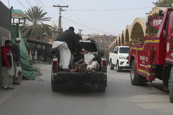 Injured victims of a suicide bombing are transported toward a hospital in Peshawar.