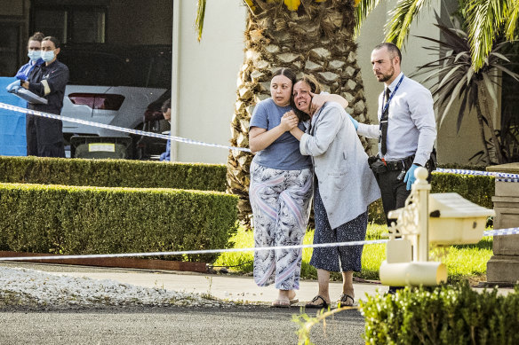 Distraught loved ones in front of John Latorre’s Greenvale home on Tuesday morning.