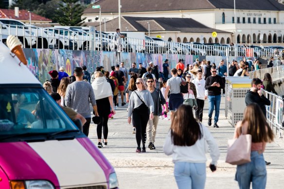 Crowds flocked to the grass and walkways at Bondi Beach on Sunday.