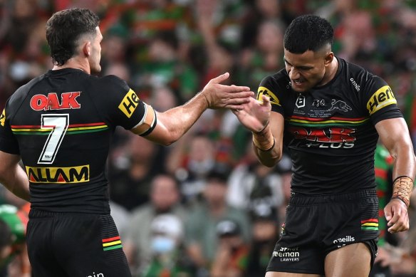 Nathan Cleary and Stephen Crichton celebrate a Panthers try by sharing some skin.