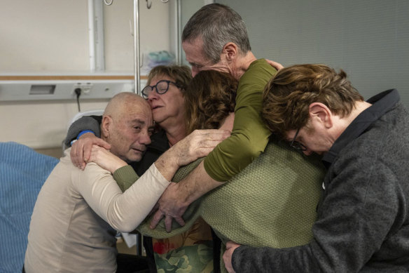 Hostage Luis Har (left) is hugged by relatives after being rescued.