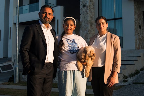 Raj and Aman Mangat with their youngest daughter Iskara and dog Simba in Box Hill.