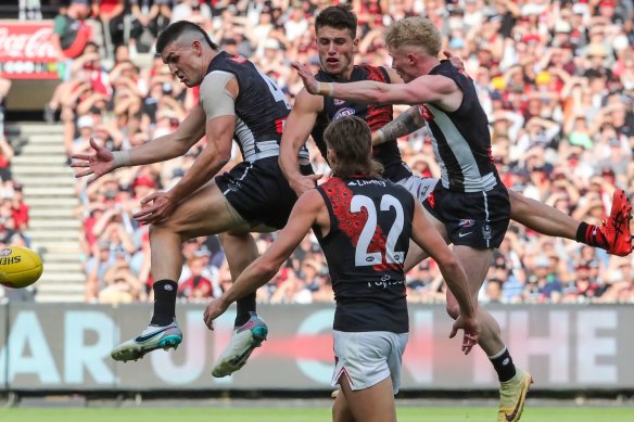 Brayden Maynard (left) and John Noble of Collingwood compete for the ball against Archie Perkins of Essendon in theÂ AnzacÂ Day match at the MCG on 25th April,Â 2023. Photo:Â PaulÂ Rovere
