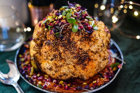 Christmas centrepiece: Whole-roasted spice-rubbed cauliflower sitting on romesco.