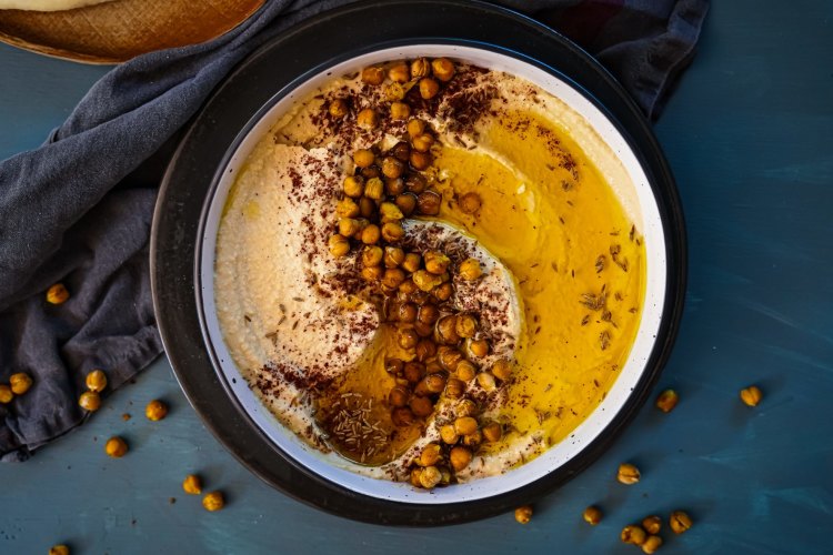 Preserved lemon hummus with cumin and sumac roasted chickpeas. Ottolenghi inspired mix and match Middle Eastern share friendly feast recipes for Good Food, October 2019. Images and recipes by KatrinaÂ Meynink. Good Food use only.