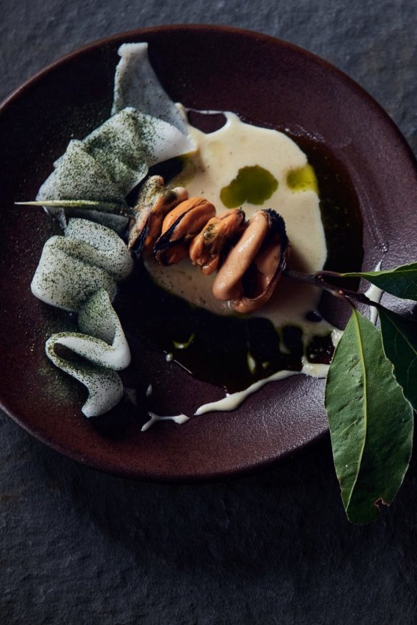 Grilled blue mussels on a bay leaf spear.