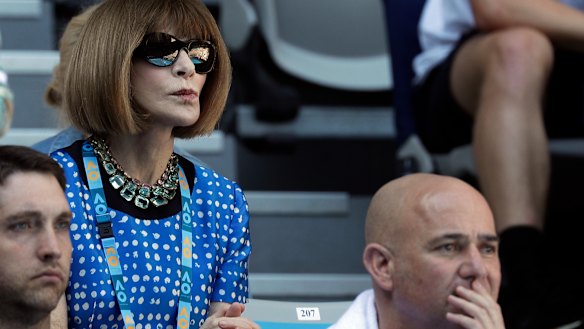 Power play ... Anna Wintour watches the Australian Open behind tennis legend Andre Agassi on Sunday.