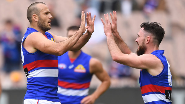 Tory Dickson (left) celebrates one of his three goals against Hawthorn with Bulldogs teammate Toby McLean.