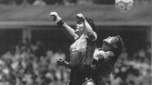 Diego Maradona beats English goalkeeper Peter Shilton to a high ball and scores the "Hand of God" goal off his left hand in the 1986 World Cup quarter-final.