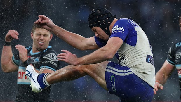 Matt Burton kicks during the Bulldogs’ NRL loss to the Sharks.