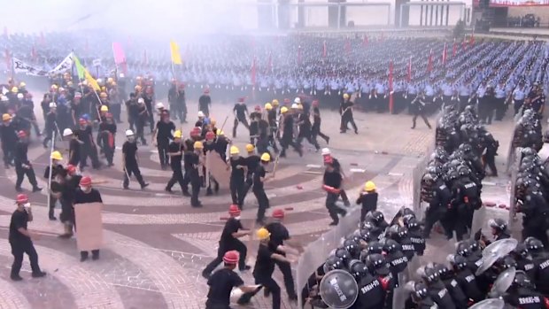 A simulated protest in front of 12,000 Chinese mainland police doubles as a stark warning to protesters in neighbouring Hong Kong.