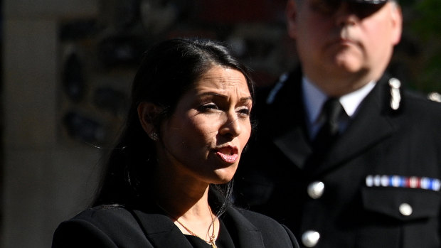 British Home Secretary Priti Patel speaks to the media on Monday.