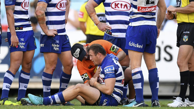 High elbow: Josh Morris stays down after a collision with Sam Burgess. 