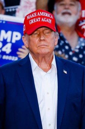 Donald Trump sports his MAGA headware.