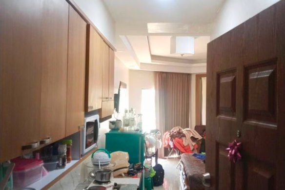 Empty spirits bottles and saucepans visible in the apartment.