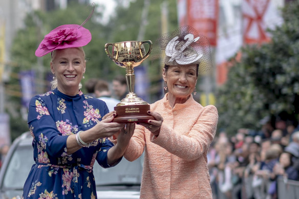 Lord mayor Sally Capp with VRC chairman Amanda Elliott holding the $200,000 Cup during the parade.