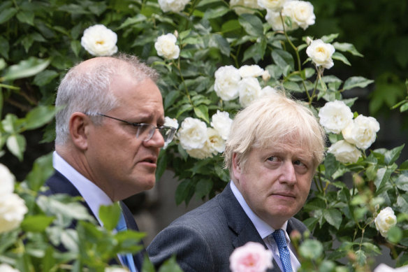 Prime ministers Scott Morrison and Boris Johnson walk to their joint press conference in the Downing Street garden.
