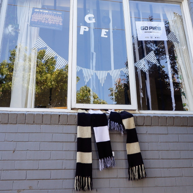 Glenn Peters hangs his Pies scarf outside his window.