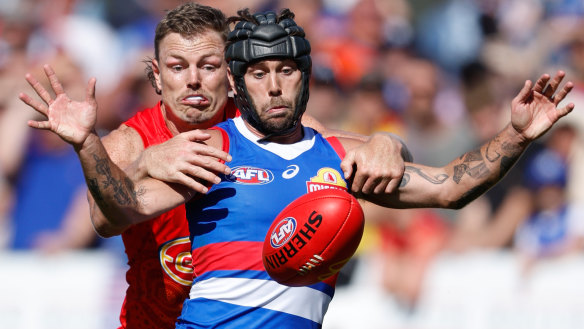 Caleb Daniel fights for the ball with typical ferocity on Sunday against Gold Coast’s Nick Holman.