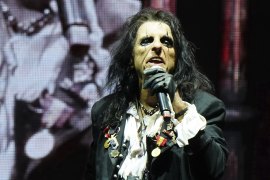 Everyone feared this festival would implode, but there’s Alice Cooper waving a boa constrictor on stage