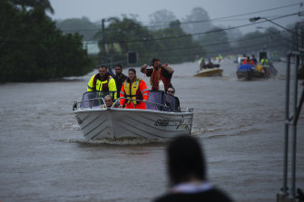 Rescue workers on swollen waters amid Lismore’s flood.