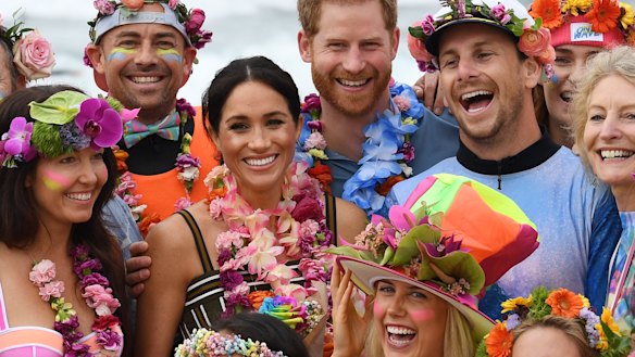 Britain's Prince Harry, the Duke of Sussex and his wife Meghan, the Duchess of Sussex, on Bondi Beach on Friday.