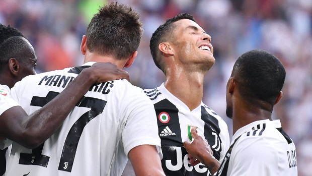Accidental hero: Mario Mandzukic celebrates with teammate Cristiano Ronaldo during the victory over Lazio.