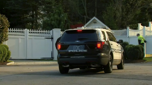 A police car sits outside the home of Bill and Hillary Clinton on Wednesday.