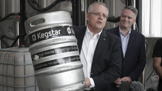 Treasurer Scott Morrison flanked by Finance Minister Mathias Cormann announces changes to beer taxes on Friday. 