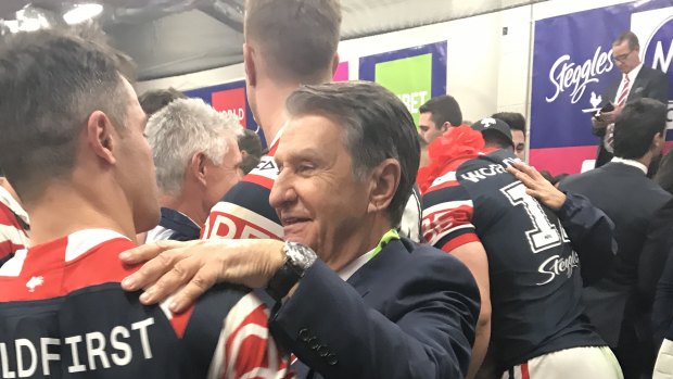 Knock on effect: Roosters chairman Nick Politis eventually got into the dressing-room after the grand final win.