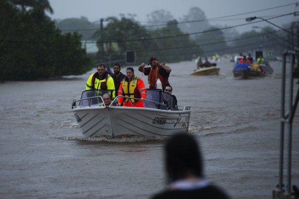 Rescue workers on swollen waters amid Lismore’s flood.