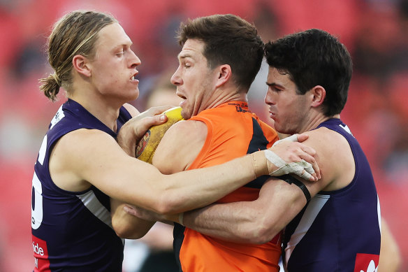 Toby Greene of the Giants is tackled by Hayden Young of the Dockers during the round 14. 