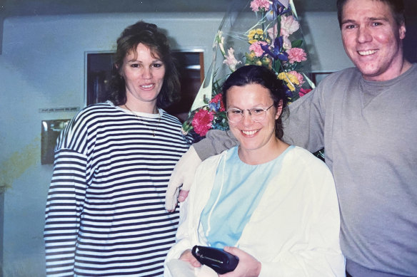 Mark Mulder and his wife, Liz, with Wood (centre) after she helped him survive burns to 92 per cent of his body.