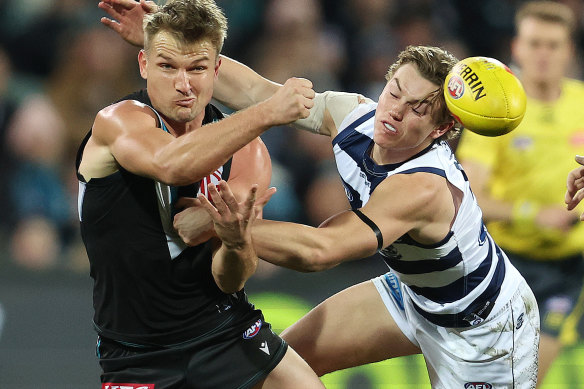 Ollie Wines of the Power and Tanner Bruhn of the Cats during the  Round 14 match.